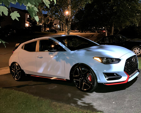 Thumbnail description followed by link description: A Hyundai Veloster N in Performance Blue in a driveway at night time.